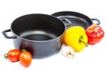 Metal pots and pans with vegetables. Royalty Free Stock Photo