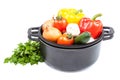 Metal pots and pans with vegetables. Royalty Free Stock Photo