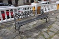 A metal public seat with a ornate wrought iron pattern in a public plaza in Estepona in Spain Royalty Free Stock Photo