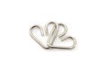 Metal puzzle in the form of hearts on a white background. Royalty Free Stock Photo