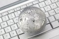 Metal puzzle globe on keyboard Royalty Free Stock Photo