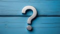 Metal question mark on blue wooden background Royalty Free Stock Photo