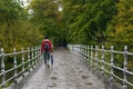 Metal railing bridge after a rainy day and woman cross the bridge with closed umbrella