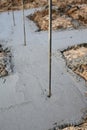 Metal Rebar sticking out of Concrete Poured Footing Foundation