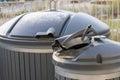 Metal recycling container filled with sorted metal waste. A metal pan sticks out of the bin, showing the process of waste sorting Royalty Free Stock Photo