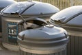 Metal recycling container filled with sorted metal waste. A metal pan sticks out of the bin, showing the process of waste sorting Royalty Free Stock Photo