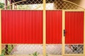 Metal red Fence with Door and Gate of Modern Style Design Metal Fence Ideas. Front view Royalty Free Stock Photo