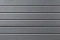 Metal reflective gray grooved surface. Grey metalline background, texture. Metallic gate in the line close-up. Abstract ribbed tex Royalty Free Stock Photo