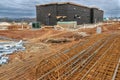 Metal Reinforcements Lie In Foreground of New Commercial Construction Site Royalty Free Stock Photo