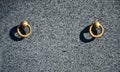 Metal ring on grave of cemetery. Rusty iron handle on granite tomb cover. An 19th century antique cemetery in Lvi