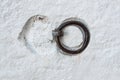 Metal ring with recesses of the old texture white concrete wall. Background. Royalty Free Stock Photo