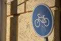 metal road sign bicycle lane and wall Royalty Free Stock Photo