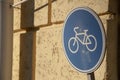 Metal road sign bicycle lane and wall Royalty Free Stock Photo