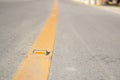 Metal road stud with yellow line on the road Royalty Free Stock Photo