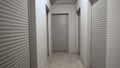 Metal roller shutters on warehouse doors. Storage rooms in the basement of a multi-story residential building. Room for Royalty Free Stock Photo