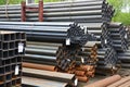 Metal rolling. Round and square tube are stacked in storage and loading at the warehouse.