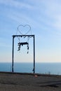 Metal romantic swing on the mountain above the cliff. dramatic natural landscape with swing