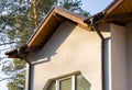 Metal roof with rain gutter on a part townhouse building under construction.