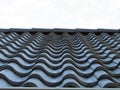 Metal roof tile. Roof tile in line. Row of black tile. Royalty Free Stock Photo