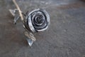 Metal rose on shabby wooden background