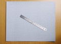 Metal ruler on sandpaper