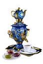 Metal Russian samovar, with traditional ornaments and paintings. On a white background