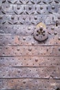 Metal rust door with a forged pattern with rings for knocking Royalty Free Stock Photo