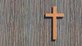 Metal rusted cross on a natural wood or wooden logg background. 3d illustration metaphor for God, Christ