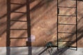 Metal rusty fire escape on the red wall of an old house. Royalty Free Stock Photo