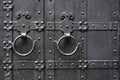 Metal rusty round handle on black wooden door. Royalty Free Stock Photo