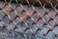 Metal rusty security fence on blurred background