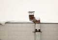 Metal rusty square pipe for exhaust and ventilation on the wall of the house. Royalty Free Stock Photo