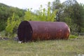 Metal rusty storage tanks for mercury next to the world heritage mountain and the chemical plant for the production of