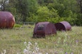 Metal rusty storage tanks for mercury next to the world heritage mountain and the chemical plant for the production of