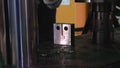 Metal sample is tested for compressive strength. Footage. Close-up of metal strength test in laboratory using press