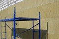 Metal scaffolding blue installed at the wall, which is repaired Royalty Free Stock Photo
