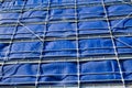 Metal scaffolding at construction building site with the blue cover up. Royalty Free Stock Photo