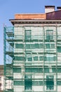 Scaffolding with green safety net near building facade Royalty Free Stock Photo
