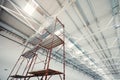 Scaffolding standing in empty warehouse building under construction Royalty Free Stock Photo