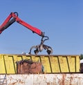 Metal scrap yard with grabber Royalty Free Stock Photo