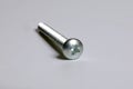 Metal screw plug on white background