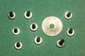 Metal screws with washer on green craft paper
