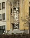 Metal sculpture on a concrete base composed of the letters O and C representing Oklahoma City.