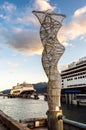 Metal sculpture on dock with cruise ships, late afternoon. Juneau, Alaska, USA. Royalty Free Stock Photo