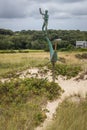 Metal sculpture of a harpooner on the beach