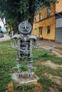 Metal sculpture of robot made from details of old cars and scrap metal