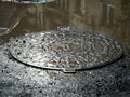 Metal sewage cover in the flooded city