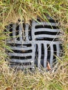 Metal sewer grate in the grass. Royalty Free Stock Photo