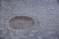 Metal sewer hatch on street tiles outdoors, space for text