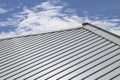 Metal sheet roof and slope with clouds and blue sky